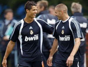 Real Madrid soccer players Ronaldo and Benzema share a joke during a training session in County Kildare