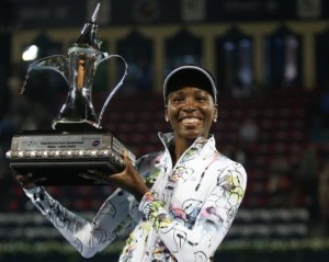 Williams of the U.S. holds the trophy after defeating Cornet of France in their women's singles final match at the Dubai Tennis Championships
