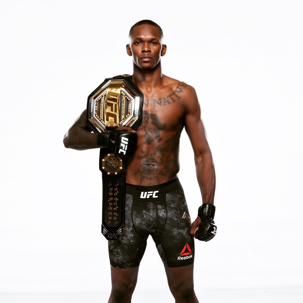 Israel Adesanya with his UFC title.
