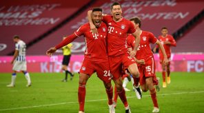 Bayern Munich players celebrate with Robert Lewandowski as he scored four against Hertha Berlin To help them bounce back to winning ways.