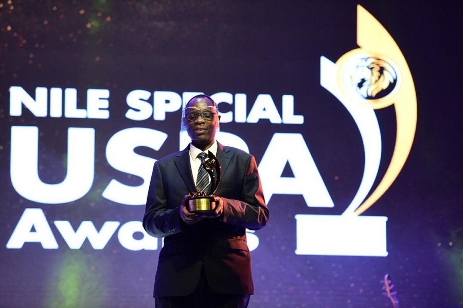 Dominic Otuchet with the award of Joshua Cheptegei.