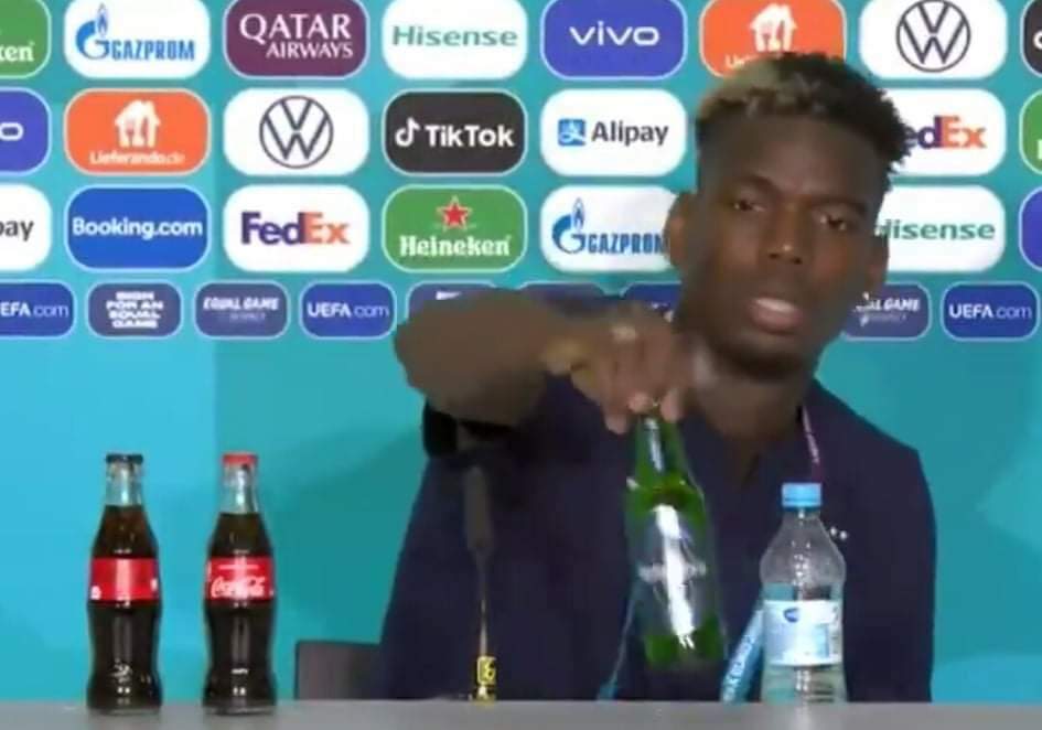 Paul Pogba removing the Heineken bottle.