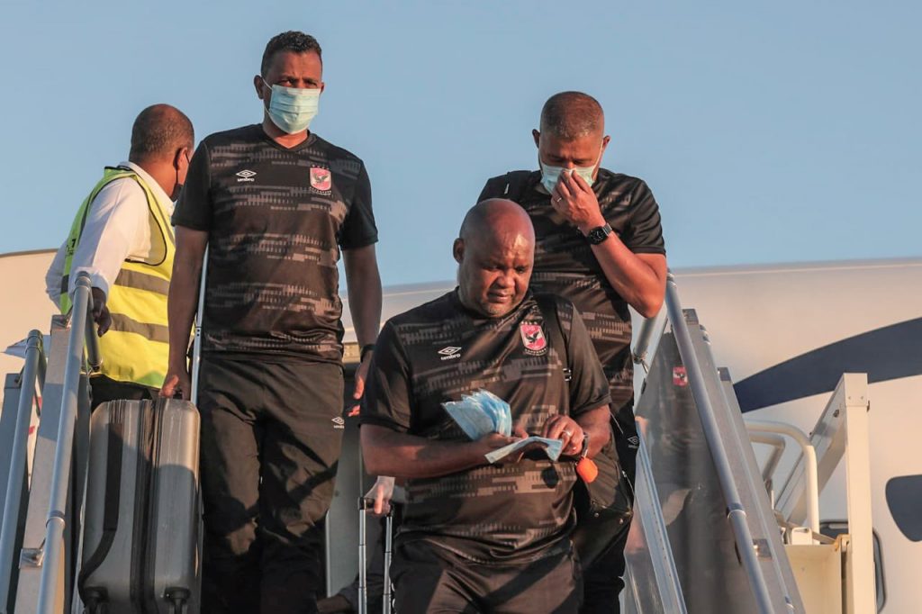 Pitso Mosimane and his assistants coming off the plane.