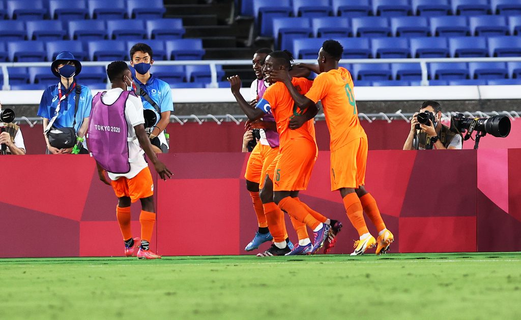Ivory Coast players celebrating their opener provoked by Max Alain Gradel in Tokyo 2020.