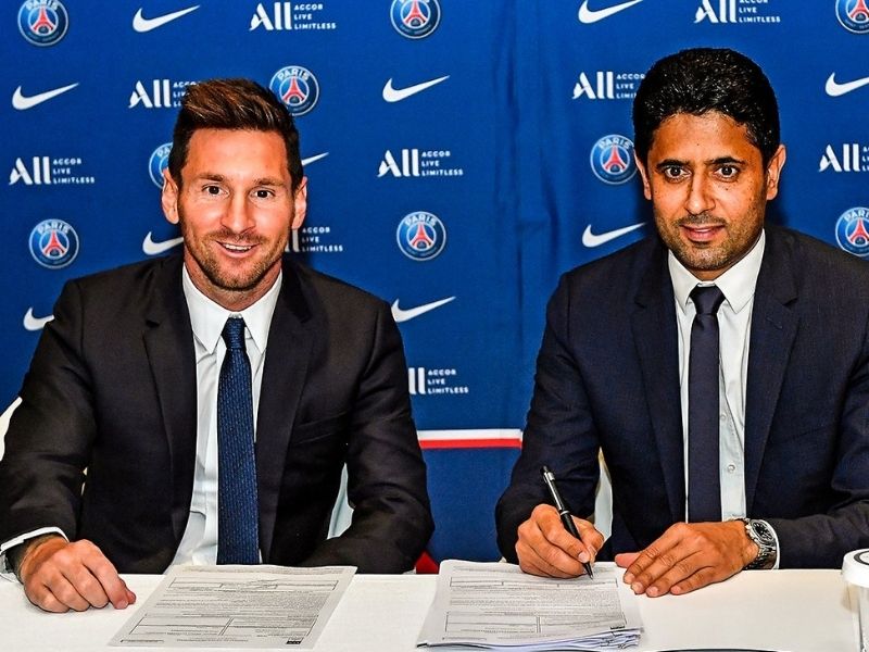Lionel Messi signing his contract alongside Nasser Al-Khelaifi, PSG chairman.