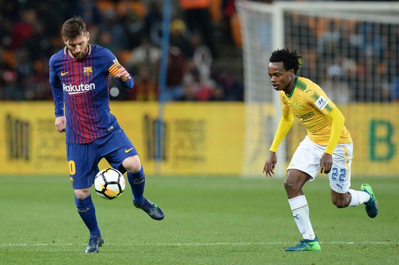 Percy Tau in action vs Leo Messi during a Sundowns-Barca match.