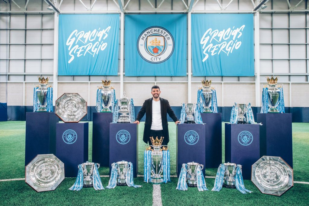 Sergio Aguero and the trophies he won with Man City.