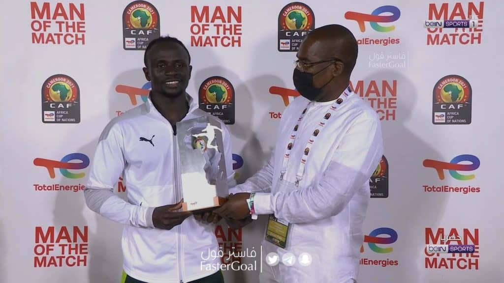 Sadio Mane receiving his MOTM Award after the game.
