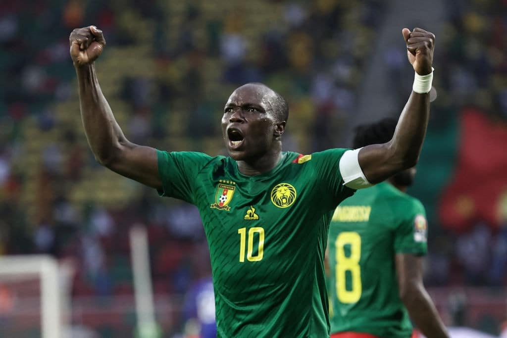 Vincent Aboubakar celebrating in front of Cameroonian fans during an AFCON game.