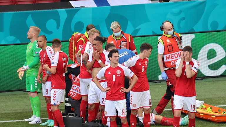 Christian Eriksen's teammates surrounding him after he collapsed vs Finland.