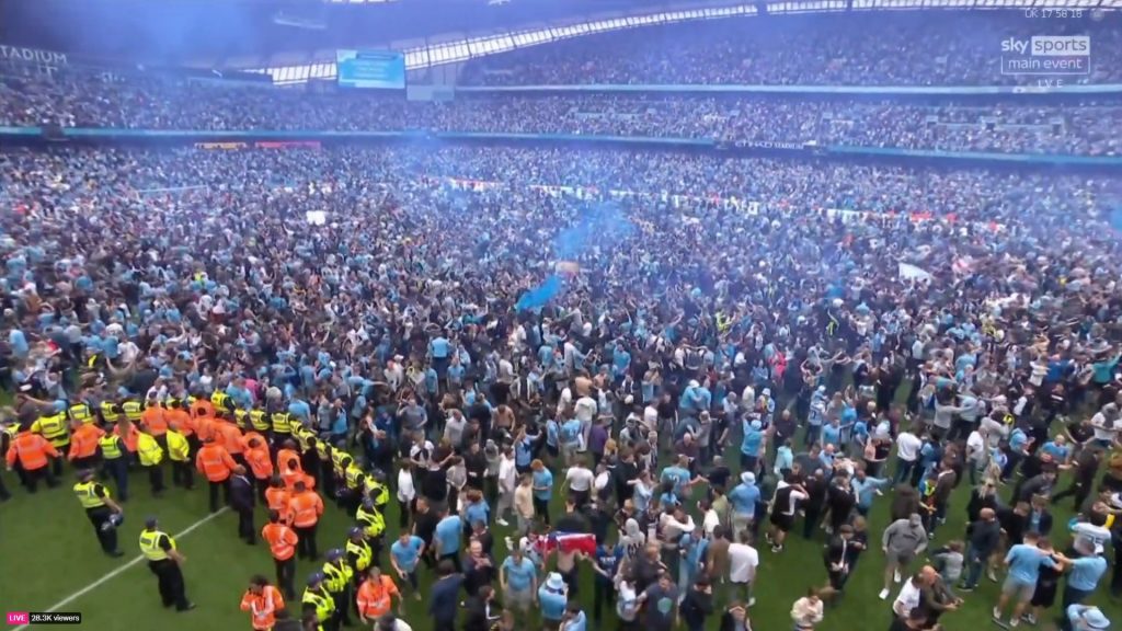 Manchester City fans invading the Etihad Stadium at final whistle.