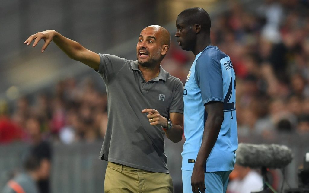 Pep Guardiola giving instructions to Yaya Toure during a Man City game.