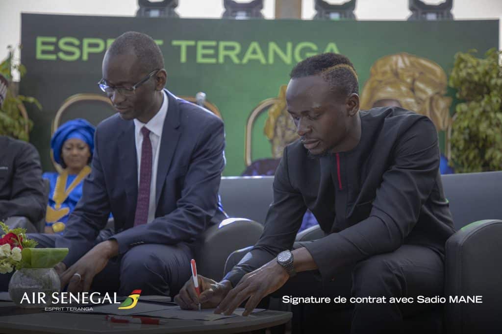 Sadio Mane signing his contract with Air Senegal.